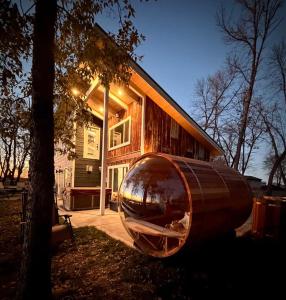 a large metal object sitting in front of a house at Designer Lake Cabin- HotTub, Sauna & Massage Chair in Ottertail