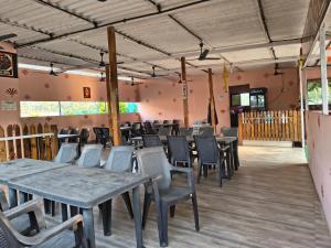 a restaurant with tables and chairs in a room at Sea view holiday resort in Borlai