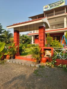 a red brick building with plants in front of it at Sea view holiday resort in Borlai