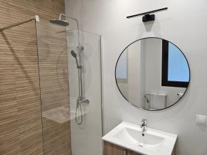 a bathroom with a sink and a mirror at Hotel Rural Mirador de Jubrique in Jubrique