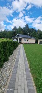 a brick walkway in front of a house at Lion Sauna in Vydmantai +39 photos