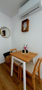a dining room table and chairs with a wooden table at Apartament w Sercu Gór z ogrodem in Wałbrzych