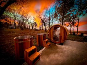 a tent and two trash cans in a park at Designer Lake Cabin- HotTub, Sauna & Massage Chair in Ottertail