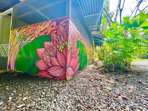 a building with a flower painted on the side of it at Ita Ita Casitas Playa Punta Uva in Punta Uva +148 photos