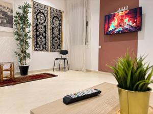 a remote control sitting on a table in a living room at Nul in Tetouan +5 photos