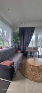 a bedroom with a bed and a coffee table at Lion Sauna in Vydmantai