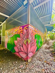 a painting of a flower on the side of a building at Ita Ita Casitas Playa Punta Uva in Punta Uva