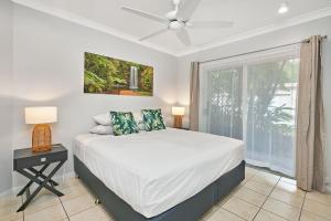 a bedroom with a large bed and a window at Coral Views at Clifton Beach in Clifton Beach