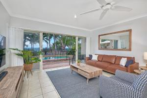 a living room with a couch and a table at Coral Views at Clifton Beach in Clifton Beach