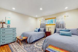 a bedroom with two beds and a dresser at Colorado Pines Retreat in Lake Valley