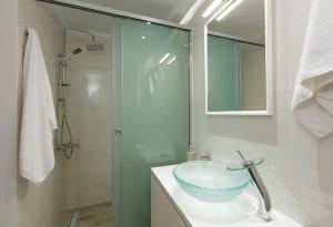 a bathroom with a sink and a glass shower at Kampos Villa Iii in Achlades +3 photos