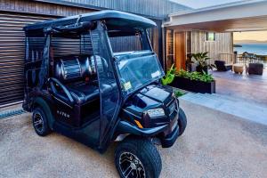 a golf cart parked in front of a building at Haven House at Hamilton Island in Hamilton Island