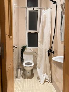 a small bathroom with a toilet and a sink at Nul in Tetouan