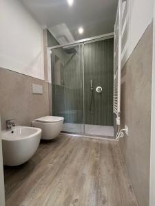 a bathroom with a shower and a toilet and a sink at Appartamenti reali - I giardini reali in Venaria Reale +6 photos