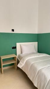 a bedroom with a bed and a side table at Nul in Tetouan