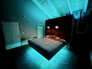 a bedroom with a bed in a room with blue lights at Designer Lake Cabin- HotTub, Sauna & Massage Chair in Ottertail +96 photos