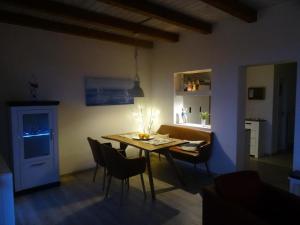 una sala da pranzo con tavolo e sedie di Ankerplatz im Strandschlösschen a Baltrum Altre 26 foto