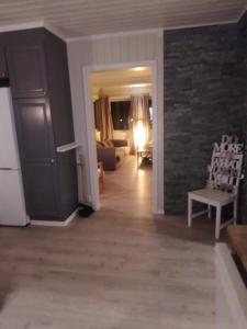 a living room with a brick wall and a couch at Skap Opplevelser in Svingvoll