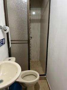 a bathroom with a shower and a toilet and a sink at Eco Hotel Parador de Rapi in Santa Rosa de Cabal
