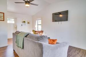 a living room with a couch and a flat screen tv at Deck and Boat Dock Lakefront Cabin in Eucha! in Eucha