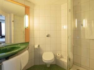 a bathroom with a toilet and a sink and a shower at Ibis Warszawa Stare Miasto in Warsaw +43 photos