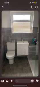 a bathroom with a white toilet and a window at Gravesend in Gravesend