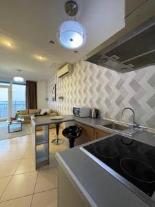 a kitchen with a sink and a counter top at Мост сити АПП 151 с терассой in Dnipro