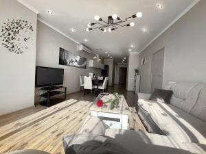 a living room with a couch and a table at Мост сити АПП 75 in Dnipro