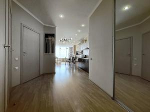 an empty living room with a large mirror on the wall at Мост сити АПП 75 in Dnipro