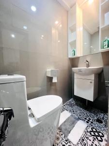 a bathroom with a white toilet and a sink at Layover at 1146 in Manila +19 photos