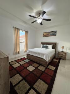 a bedroom with a bed and a ceiling fan at Fully Furnished 3BR and 2BA Gem Near Airport & Mall in McAllen