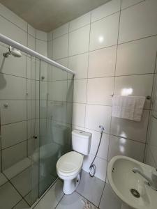 a bathroom with a toilet and a shower and a sink at Sal & Sol in Cruz