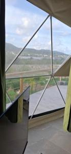 Cette chambre dispose d'une fenêtre offrant une vue sur la rivière. dans l'établissement Romantic Dome Escape in Saint-Martin, à Saint-Martin 6 autres photos