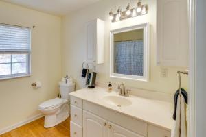 a white bathroom with a toilet and a sink at Lyles Peaceful Creekside Home Hot Tub and Fire Pit in Lyles +28 photos