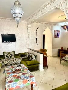 a living room with a couch and a table at appartement traditional cozy in Tangier
