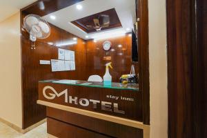 a store window with a sign for a hotel at Hotel O GM in Tirupati +21 photos