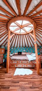 a bedroom with a bed in a yurt with a window at Yourte Voyageuse in Charette