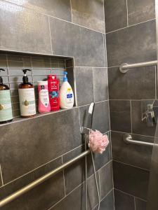 a bathroom with a shelf with cleaning products on it at Yellow Cactus Oasis in White Water