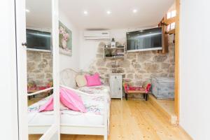 a room with a couch and a tv on a wall at Dalmatinisches Haus In Der Altstadt Von Split in Split