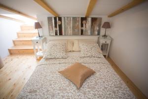 a bedroom with a large bed with two pillows at Dalmatinisches Haus In Der Altstadt Von Split in Split