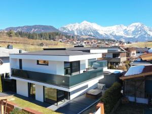 an aerial view of a house with mountains in the background at Alpin Chalet ARTE in Söll