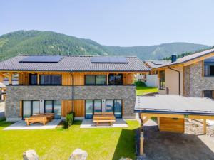 a house with solar panels on the roof at Grebenzen Lodge Edelweiss in Sankt Lambrecht