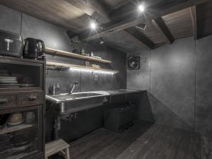 a small kitchen with a sink and a counter at 旅館 なおみ in Toba