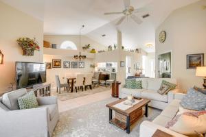 Una sala de estar con muebles blancos y un televisor. en Fort Myers Vacation Rental with Lanai and Private Pool, en Fort Myers