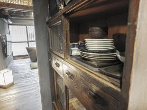a cabinet with a stack of dishes in it at 旅館 なおみ in Toba