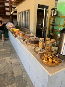 a counter with various food items on it at POUSADA ARUÁ PARATY - ''Novidade'' in Paraty