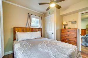 a bedroom with a bed and a ceiling fan at Lakefront Eucha Escape with Views and Boat Slip! in Eucha