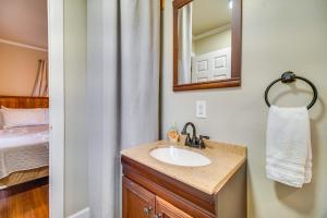 a bathroom with a sink and a mirror and a bed at Lakefront Eucha Escape with Views and Boat Slip! in Eucha +16 photos