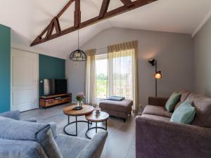 a living room with two couches and a table at Regge en Weidezicht in Hellendoorn