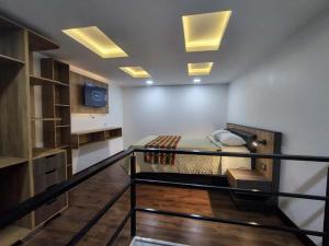 a room with a bed and a staircase with lights at Hotel Casa Santiago in Estación El Salto